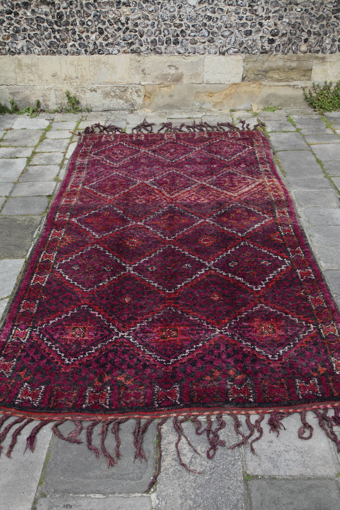 Beautiful Beni M'Guild laid out on the ground, showing the full extent of the rug and the intricate zigzag design.