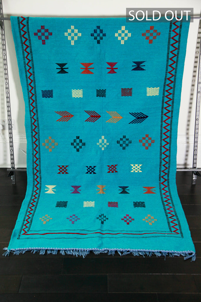 Hand-woven turquoise cotton chenille kilim with striking tribal designs and motifs. 