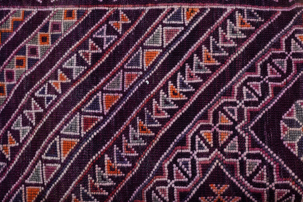 Close-up of the reverse of the rug showing the complex patterns in this rug include star formations, crosses, lozenges, chevrons, with inlaid complex geometrical designs.