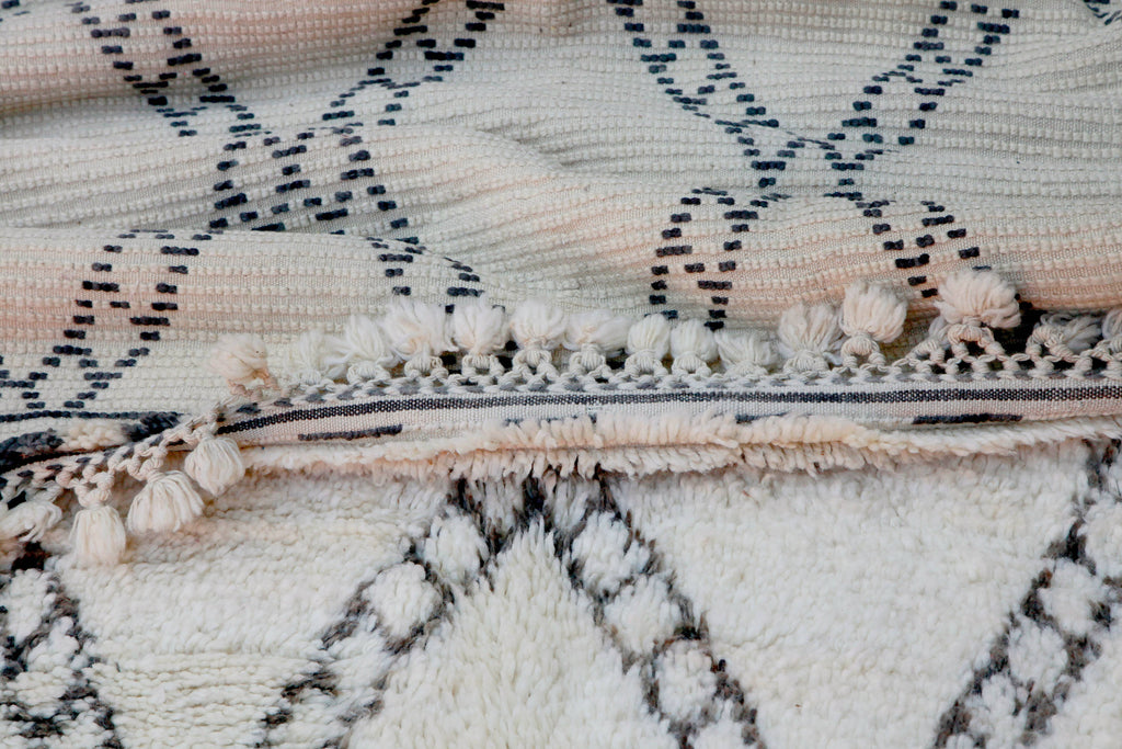 Close-up view of reverse side of hand-made Beni Ouarain rug, showing unique crocheted tassels.