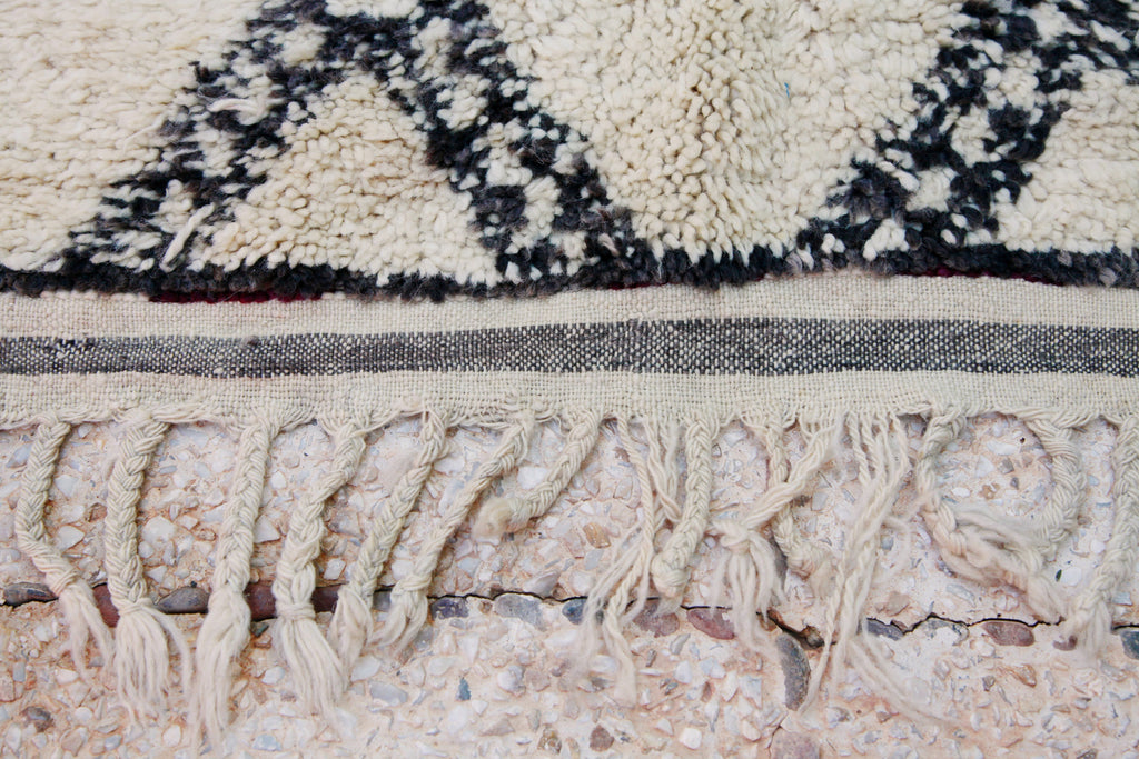 Close-up of the tassels and flat-weave border of the Beni Ouarain rug.